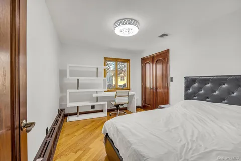 a bedroom with a large bed and a chandelier
