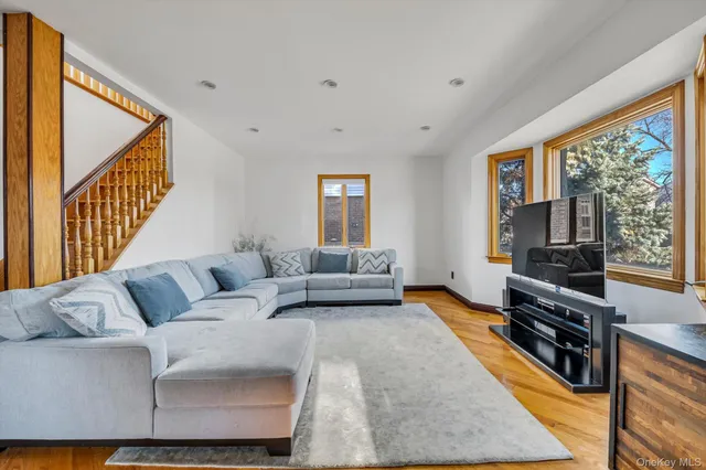 a living room with furniture large window and a flat screen tv
