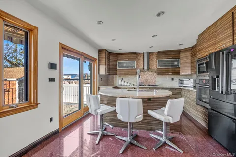 a kitchen with a dining table chairs and refrigerator