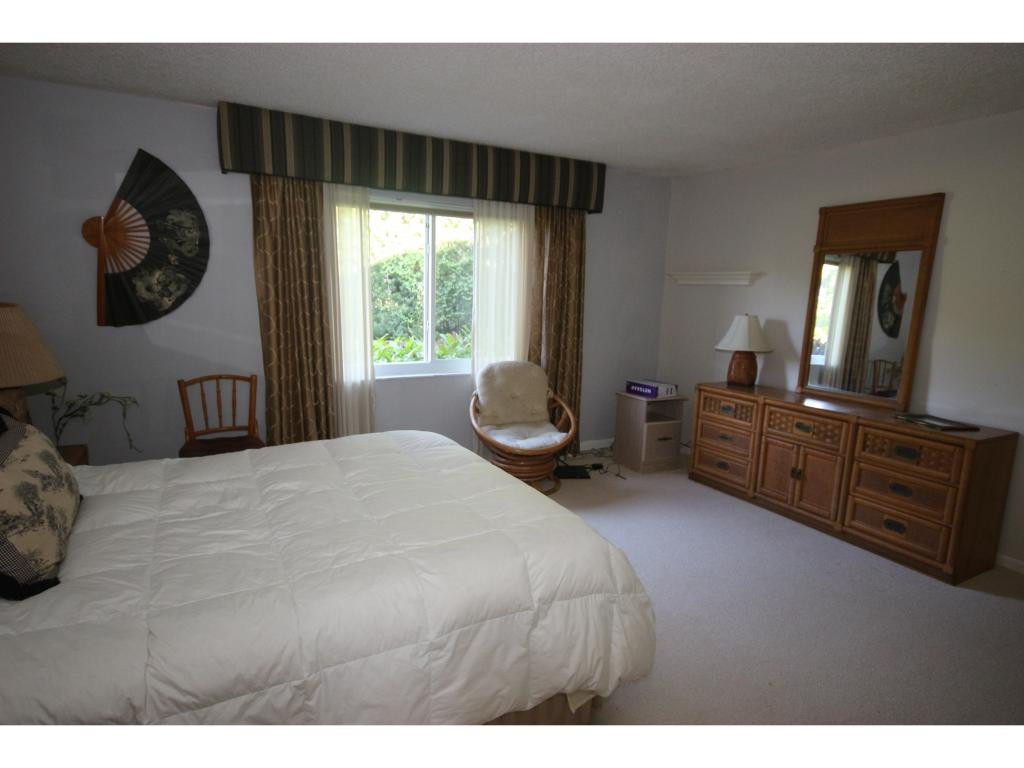 700 Teryl Road, Unit 1 Naples, FL 34112 - Photo 12 of 33 a bedroom with a large bed and a large mirror