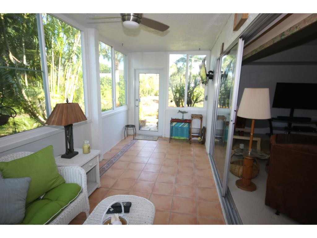 700 Teryl Road, Unit 1 Naples, FL 34112 - Photo 19 of 33 a living room with furniture and a large window