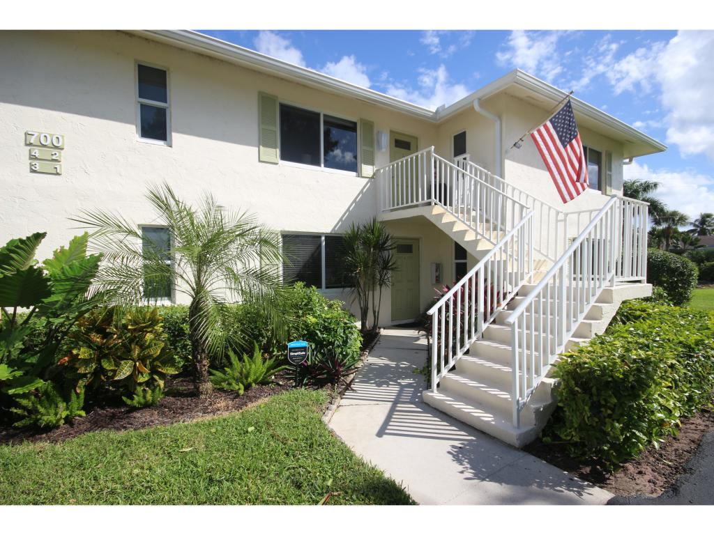 700 Teryl Road, Unit 1 Naples, FL 34112 - Photo 3 of 33 a front view of a house with a yard