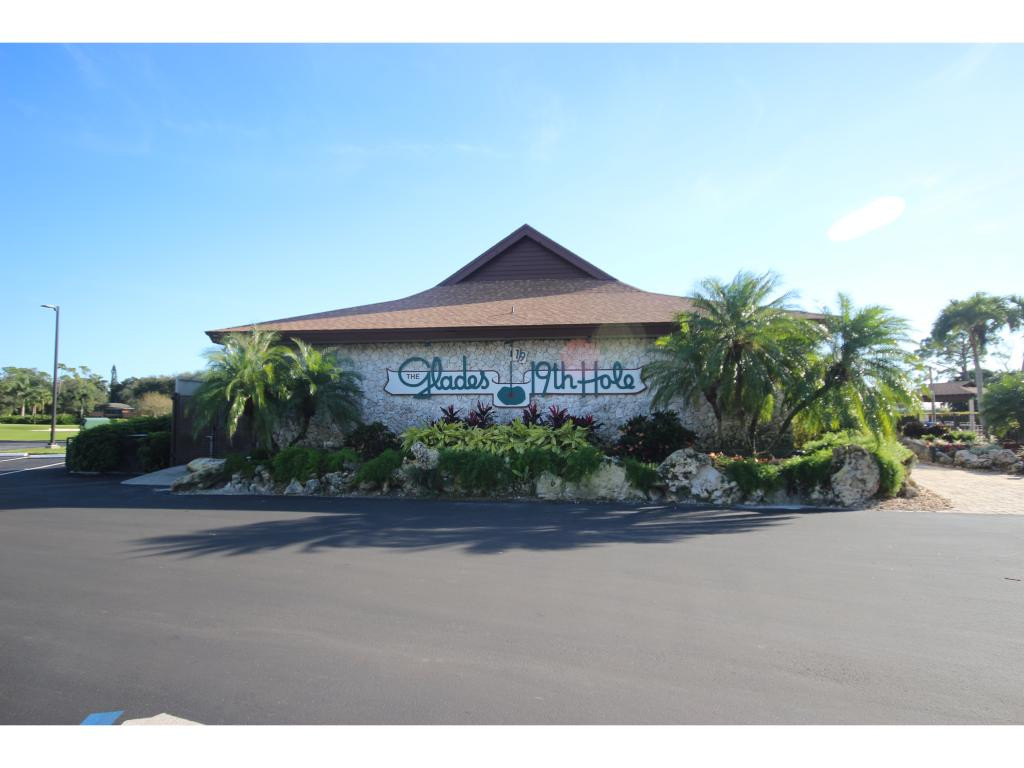 700 Teryl Road, Unit 1 Naples, FL 34112 - Photo 27 of 33 a front view of a house with plants and a yard