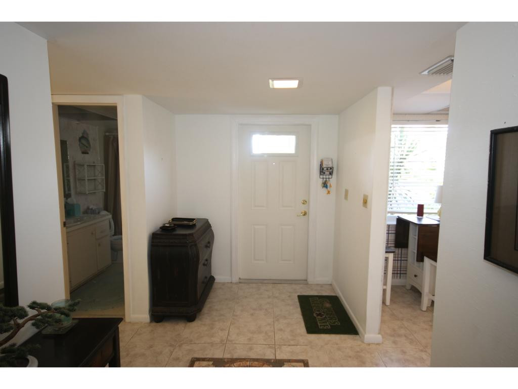 700 Teryl Road, Unit 1 Naples, FL 34112 - Photo 4 of 33 a living room with furniture and a flat screen tv