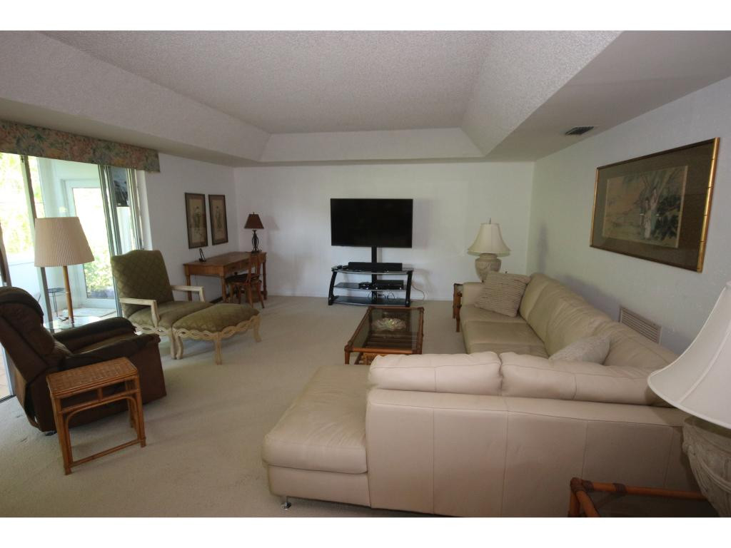 700 Teryl Road, Unit 1 Naples, FL 34112 - Photo 8 of 33 a living room with furniture and a flat screen tv