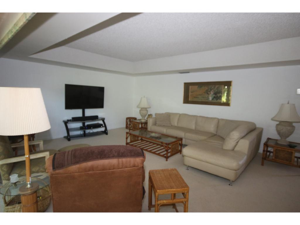 700 Teryl Road, Unit 1 Naples, FL 34112 - Photo 9 of 33 a living room with furniture a lamp and a flat screen tv