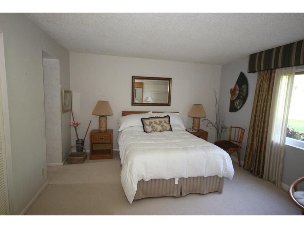 700 Teryl Road, Unit 1 Naples, FL 34112 - Photo 10 of 33 a bedroom with a bed table and a flat screen tv