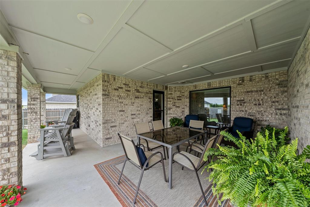 828 Agile Street Hewitt, TX 76643 - Photo 28 of 30 a outdoor space with lots of white furniture a rug and a window