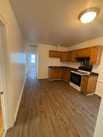 a kitchen with wooden floors and a stove