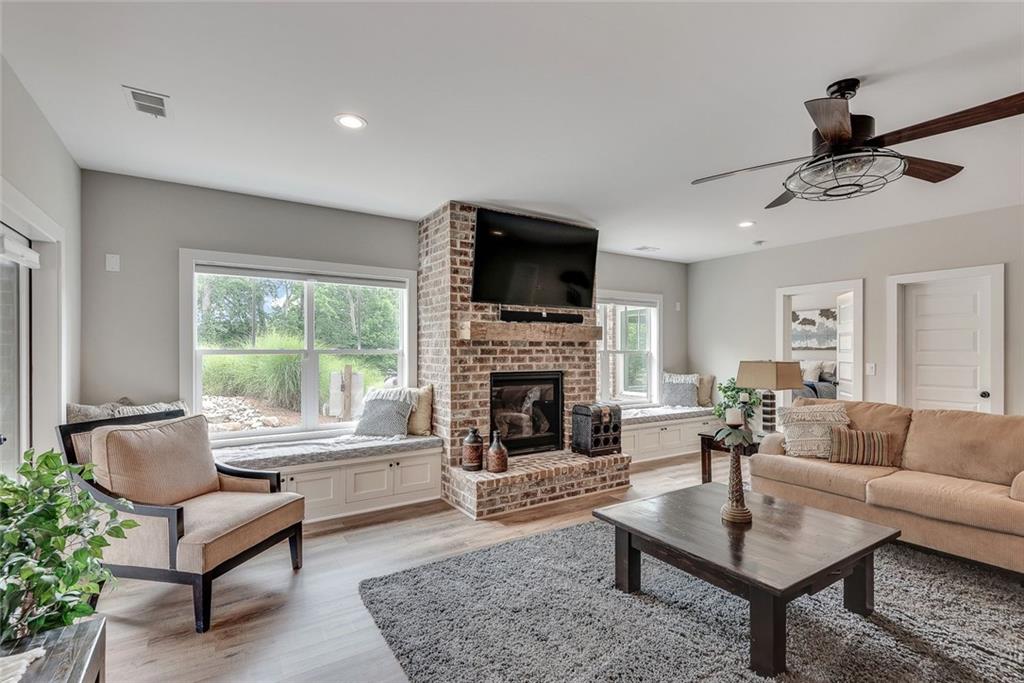 2503 Sugar Pike Road Canton, GA 30115 - Photo 128 of 134 a living room with furniture a fireplace and a flat screen tv