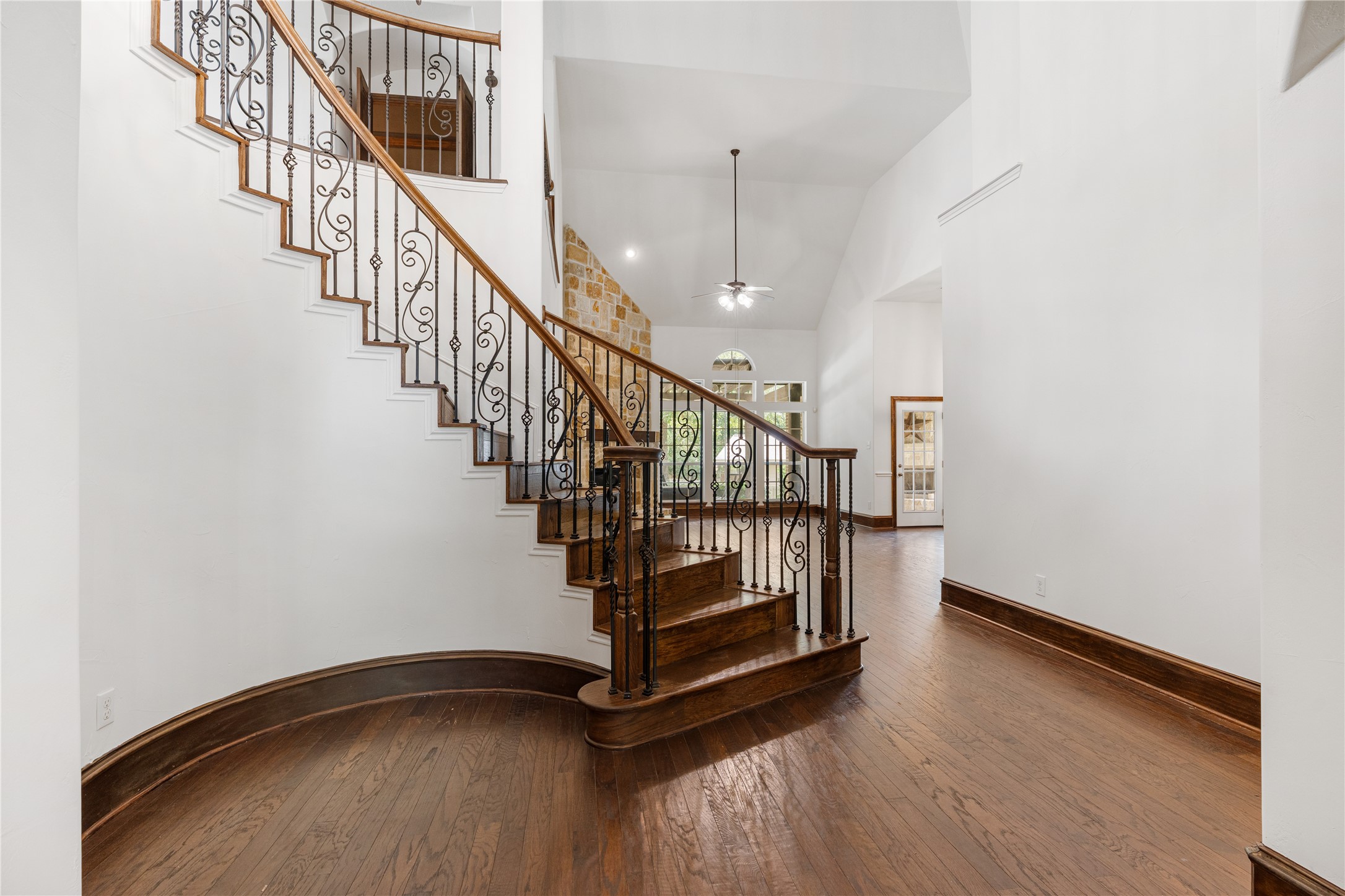 2115 Graystone Ridge Drive Conroe, TX 77304 - Photo 10 of 47 A beautiful hardwood staircase welcomes you with classic style and timeless elegance.