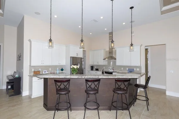 a kitchen with stainless steel appliances granite countertop a stove a sink and a refrigerator