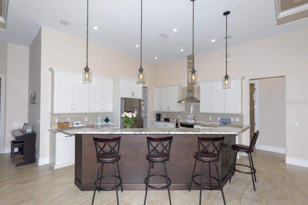 185 Colony Point Drive Punta Gorda, FL 33950 - Photo 11 of 54 a kitchen with stainless steel appliances a sink a stove a refrigerator and island