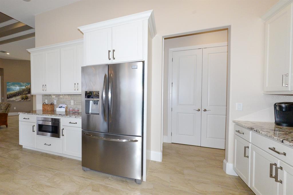 185 Colony Point Drive Punta Gorda, FL 33950 - Photo 13 of 54 a kitchen with stainless steel appliances a refrigerator stove and sink