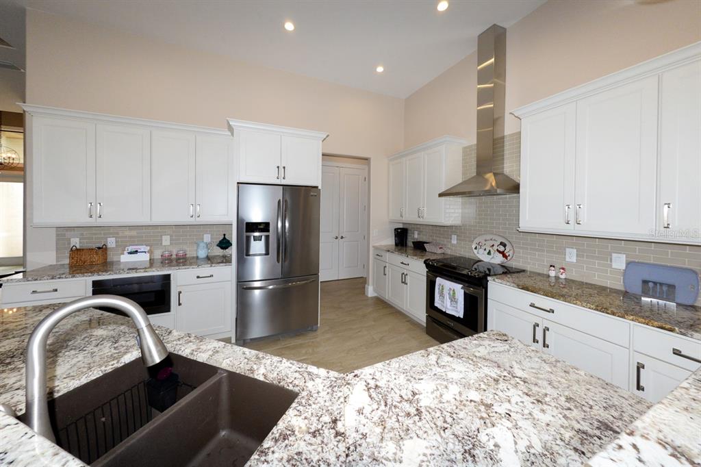185 Colony Point Drive Punta Gorda, FL 33950 - Photo 14 of 54 a kitchen with a refrigerator stove top oven and sink