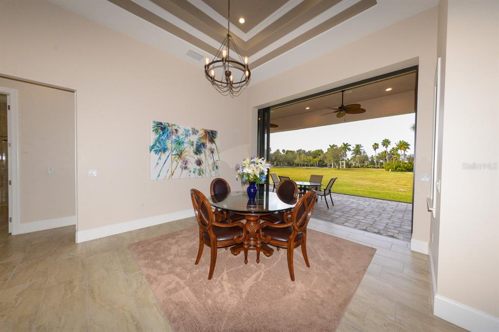 185 Colony Point Drive Punta Gorda, FL 33950 - Photo 15 of 54 a view of a dining room with furniture a rug and wooden floor