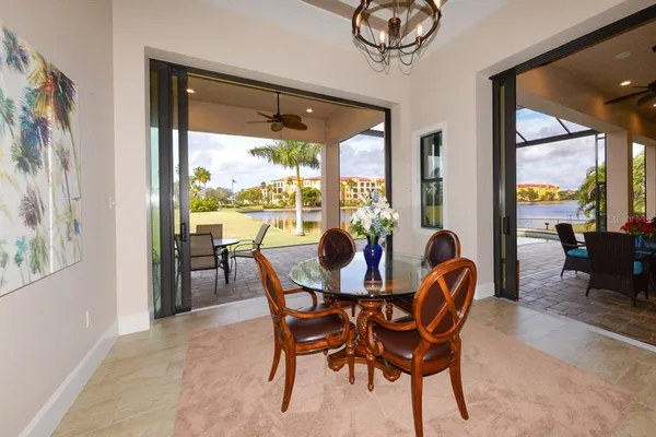 a dining room filled chandelier and kitchen view