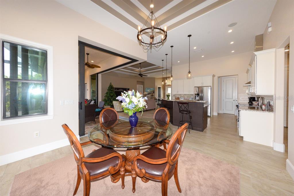 185 Colony Point Drive Punta Gorda, FL 33950 - Photo 17 of 54 a dining room filled chandelier and kitchen view