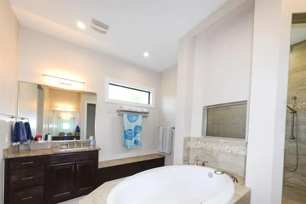 a spacious bathroom with a bathtub and a sink