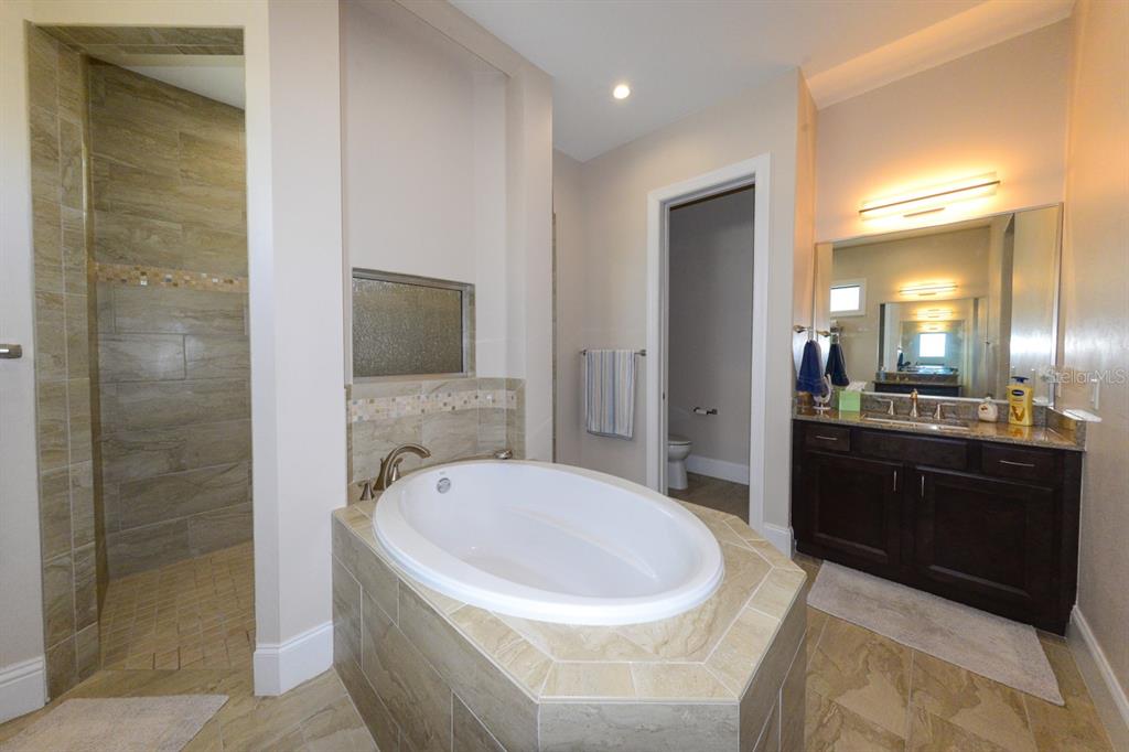 185 Colony Point Drive Punta Gorda, FL 33950 - Photo 30 of 54 a spacious bathroom with a bathtub and a sink