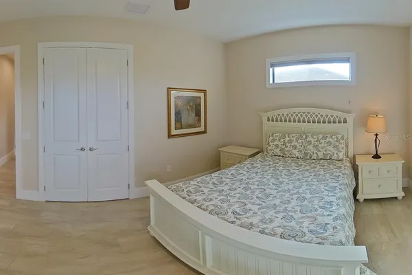 a bedroom with a bed and a chandelier