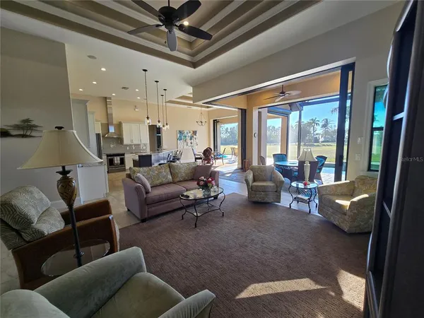 a dining room with furniture and a floor to ceiling window