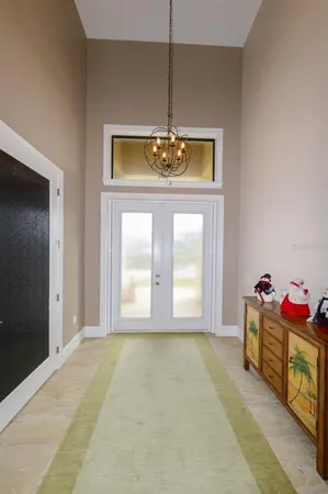 a view of a hallway with wooden floor and a dining room