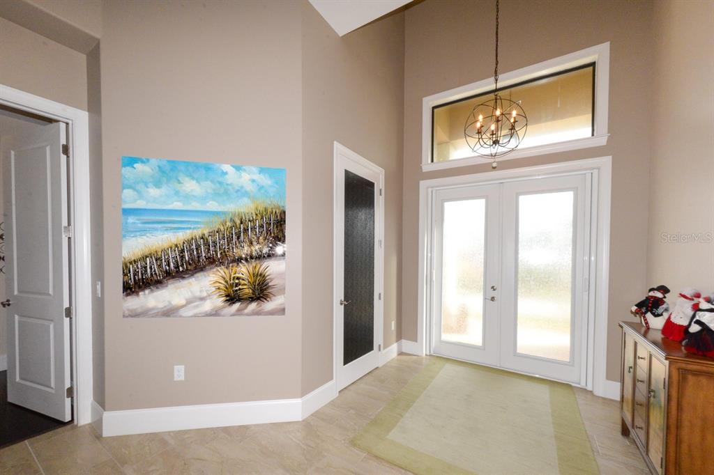 185 Colony Point Drive Punta Gorda, FL 33950 - Photo 9 of 54 a view of a hallway with wooden floor and a dining room