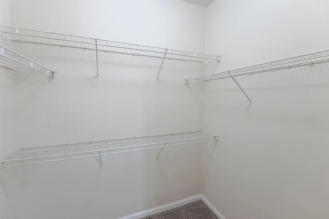 a bathroom with a granite countertop sink and a toilet