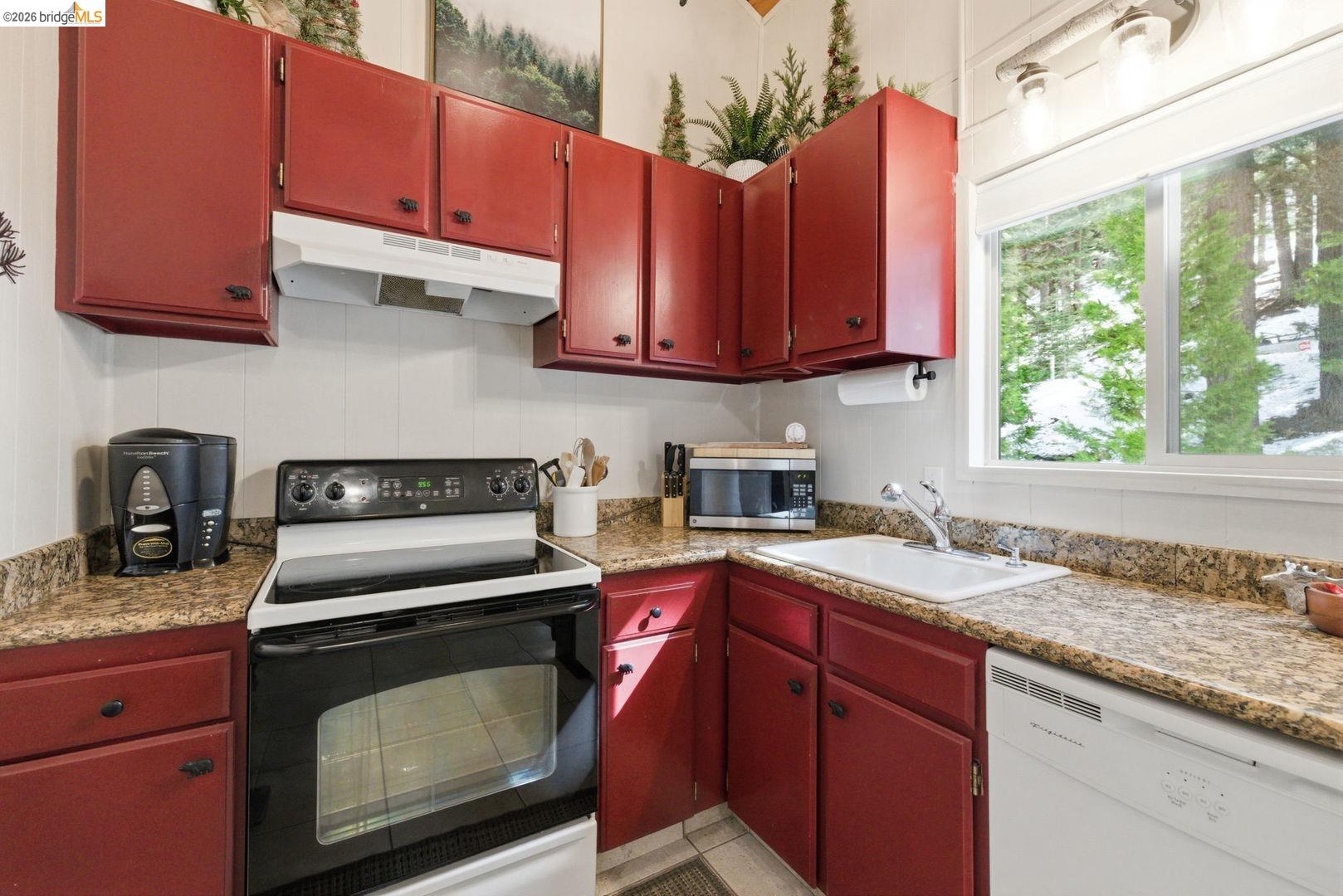 33840 Upper Leland Road, Unit 25A Pinecrest, CA 95364 - Photo 11 of 41 a kitchen with granite countertop a stove a sink and dishwasher