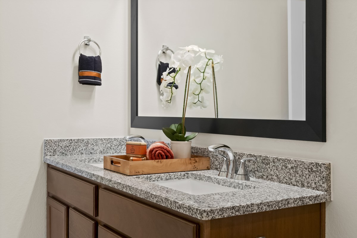 25610 White Vortex Drive Spring, TX 77373 - Photo 3 of 12 Secondary bath features tile flooring, bath/shower combo with tile surround, stained wood cabinets, beautiful granite countertops, framed mirror, sleek fixtures and modern finishes.