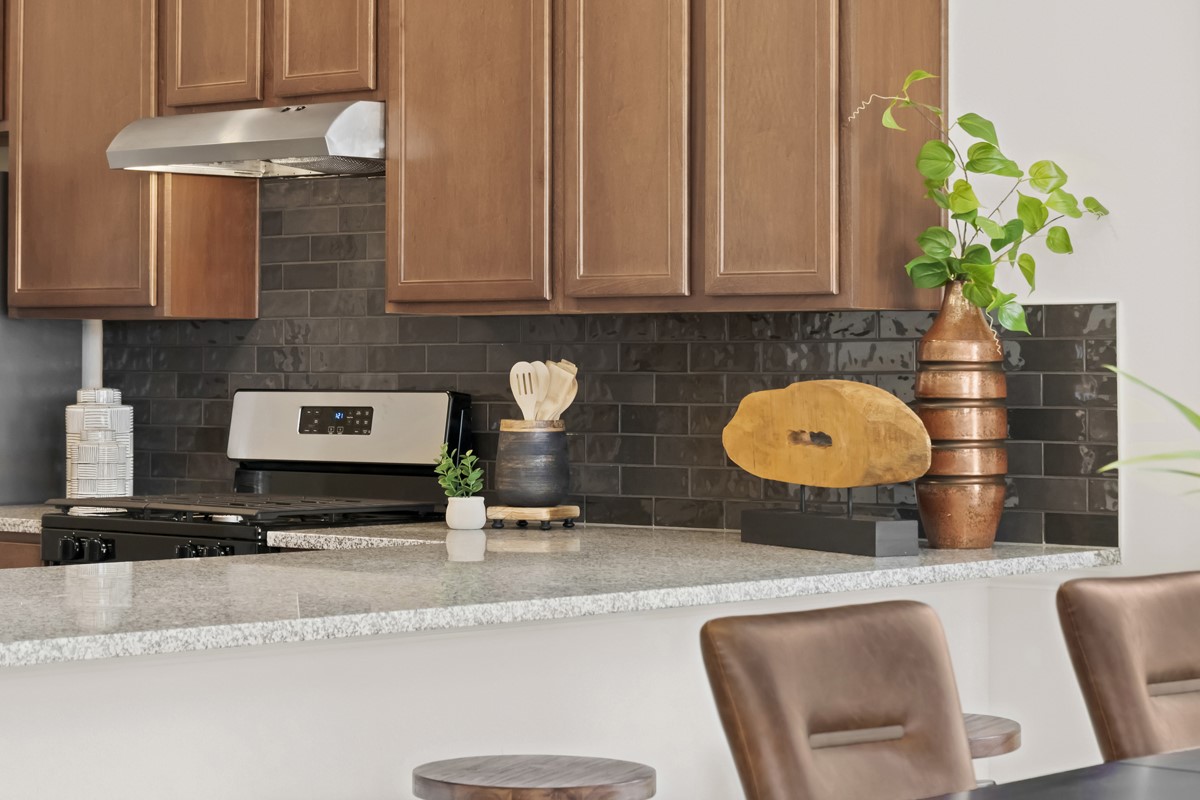 25610 White Vortex Drive Spring, TX 77373 - Photo 5 of 12 An elegant breakfast bar extends the dining area, providing a casual and inviting spot for morning meals, additional seating for guests, or a seamless workspace in the heart of the home.