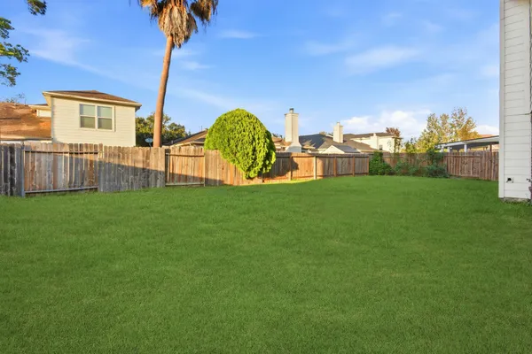 a view of a garden with a building in the background