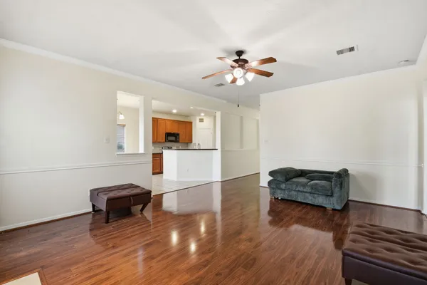 a living room with furniture and wooden floor