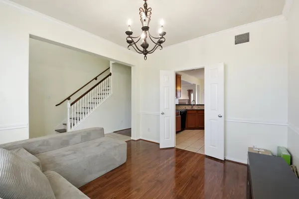 a living room with furniture and a chandelier