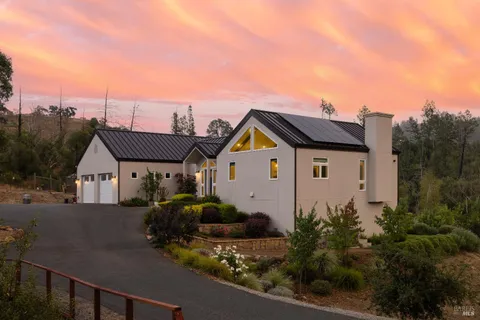 a view of a house next to a yard