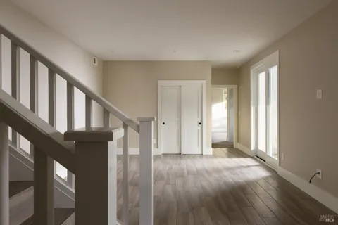 a view of an entryway with wooden floor and door