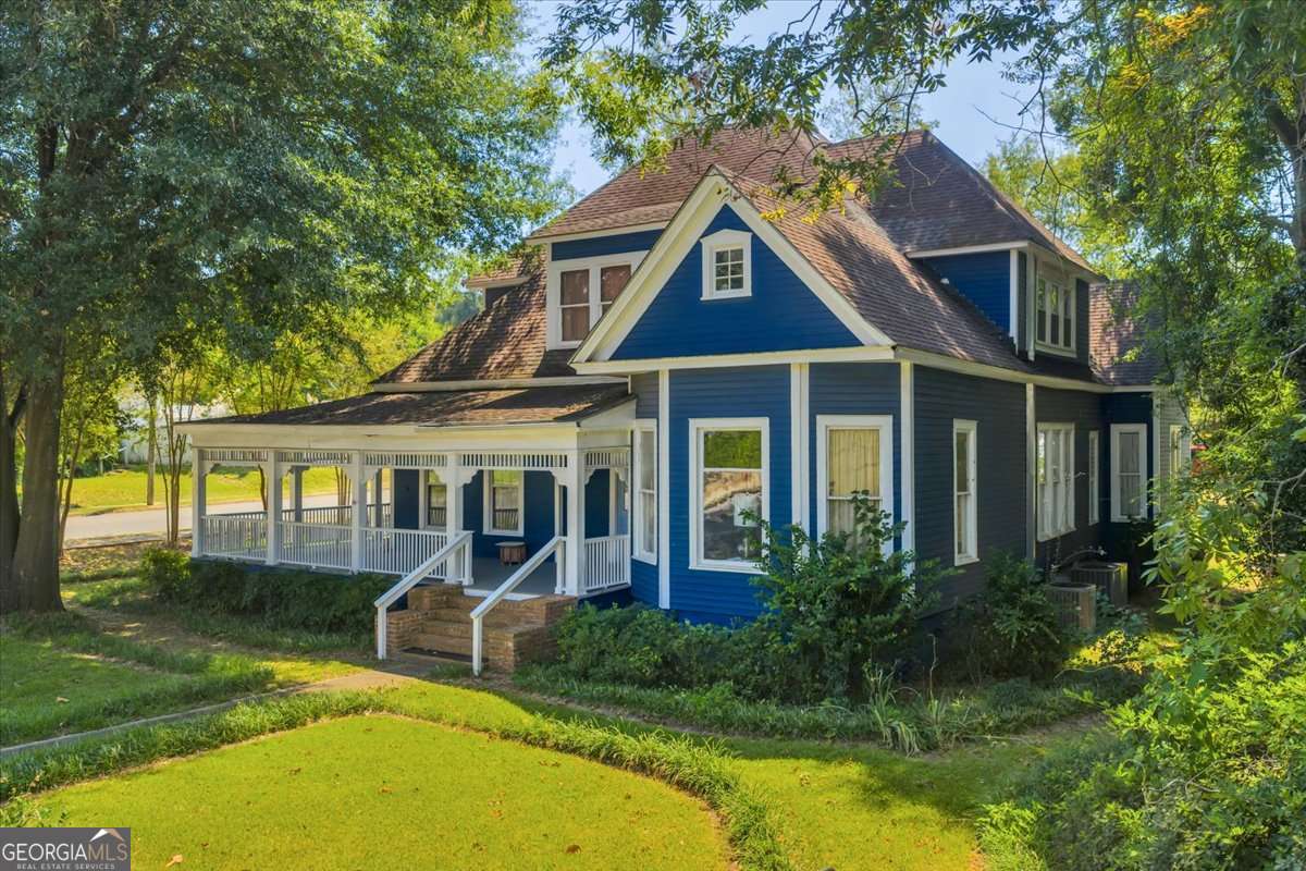 212 East Union Street Vienna, GA 31092 - Photo 55 of 62 a view of a house with swimming pool next to a yard