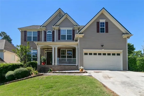 a front view of a house with a yard and garage