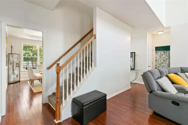 a living room with furniture and a wooden floor