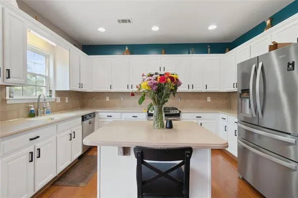 a kitchen with refrigerator a sink and cabinets