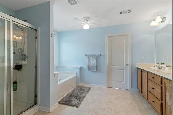 a bathroom with a tub sink and shower