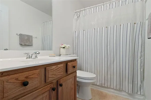a bathroom with a toilet a sink and a mirror