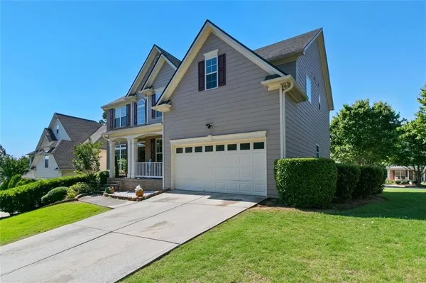 a front view of house with yard and green space