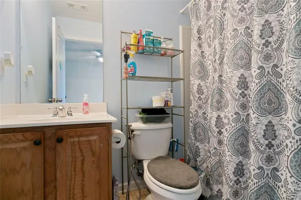a bathroom with a sink toilet and a mirror