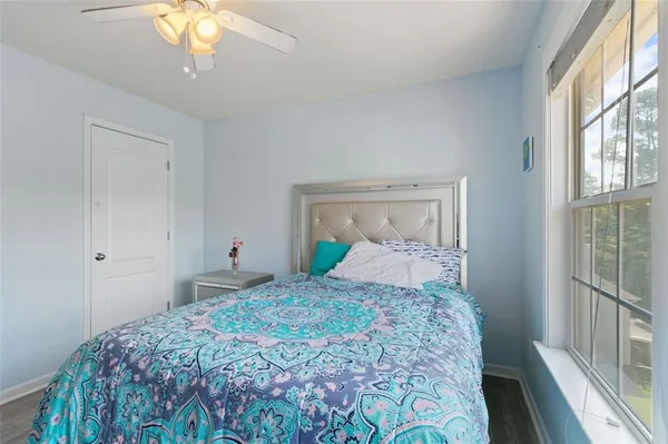 a bedroom with a bed and a window