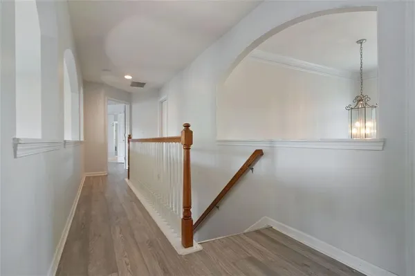 a view of a hallway with wooden floor