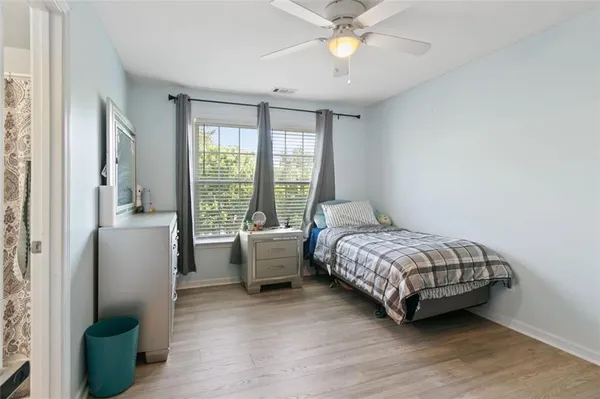 a bedroom with a bed couch and a window