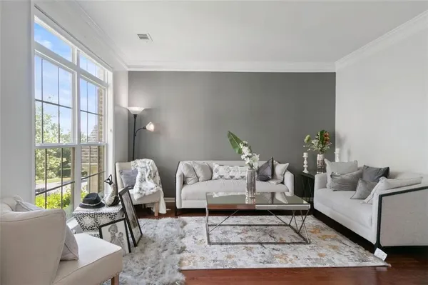 a living room with furniture and a large window