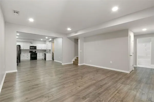 a view of an empty room with wooden floor